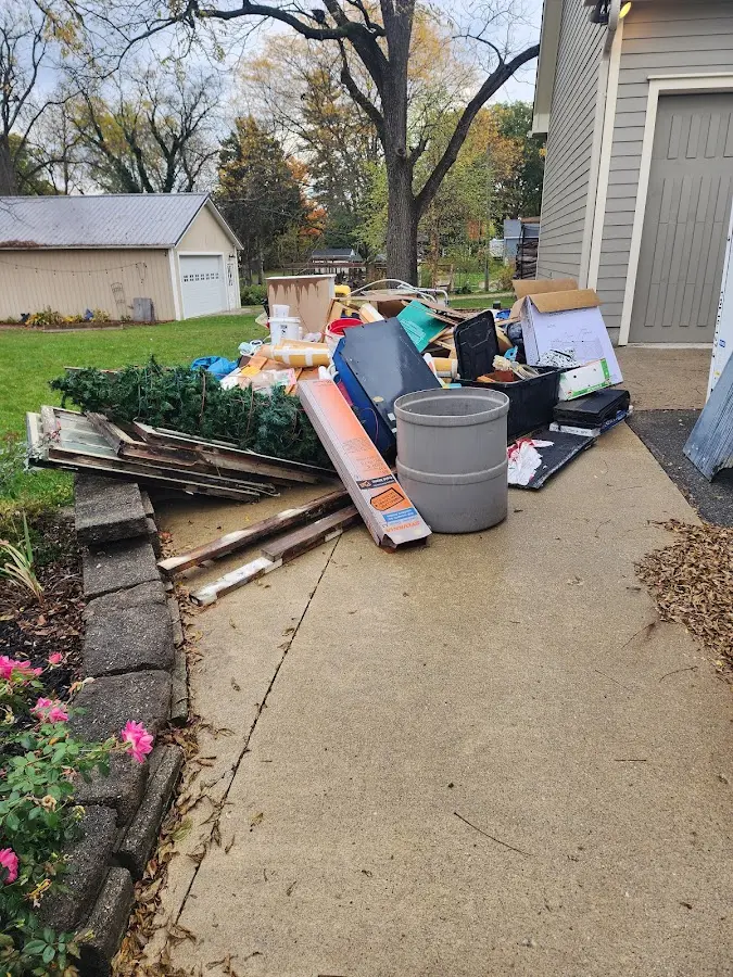 Dumpster being loaded with debris for 10 Yard Dumpster Rental in Floral Park